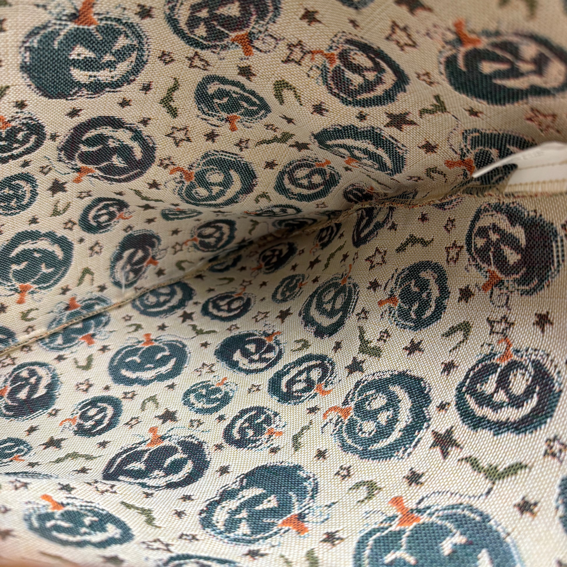 Close-up of fabric with blue pumpkins and stars pattern